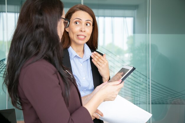 Professional businesswomen talking in conference room