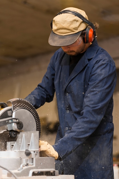 Free Photo professional carpenter uses circular saw in workshop