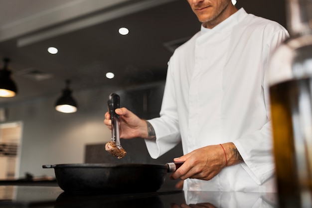 Free photo professional chef preparing food in the kitchen