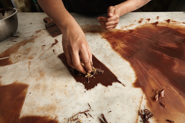 Free Photo professional chef works with melted homemade chocolate