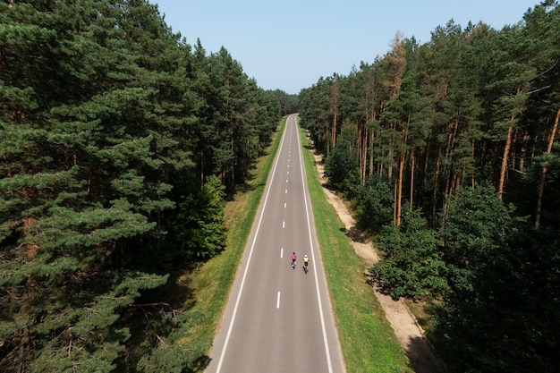 Free Photo professional cyclist women on road long shot