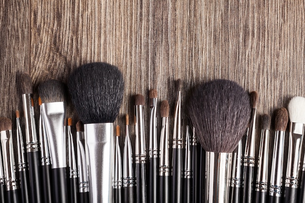 Free photo professional make-up brushes on wooden background. beauty industry