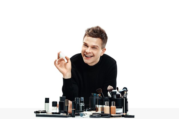 Professional makeup artist with tools isolated on white . The man in female profession. gender equality concept