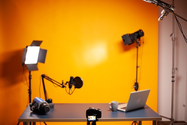 Free Photo professional podcast and vlogging setup in studio with yellow wall