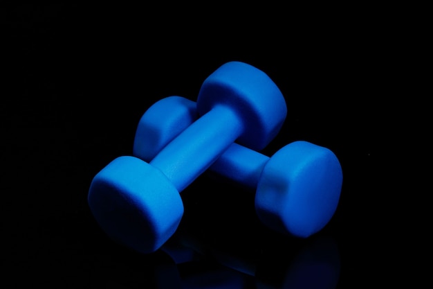 Free photo professional sport equipment isolated on black. black gym weights.