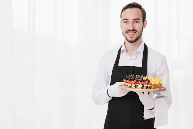 Professional waiter presenting appetizers