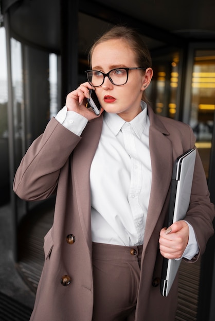 Professional woman in stylish suit at the office with laptop