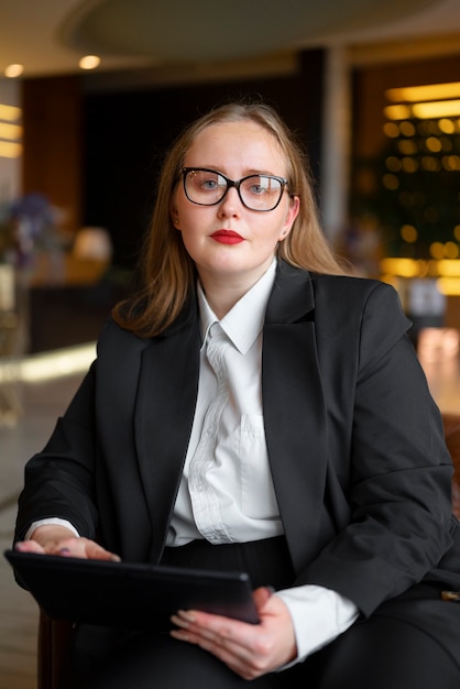 Free Photo professional woman in stylish suit at the office with tablet device