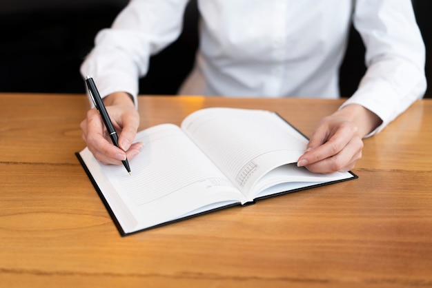 Free Photo professional woman writing in agenda