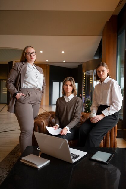 Professional women in stylish suit working with laptop at the office