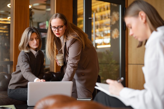 Free Photo professional women in stylish suit working with laptop at the office