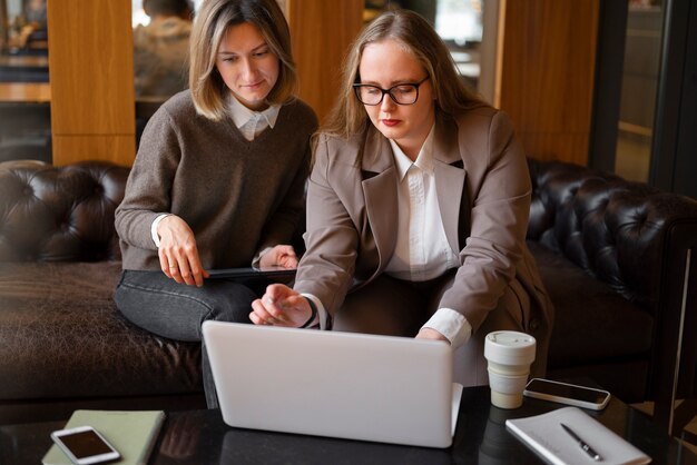 Professional women in stylish suit working with laptop at the office