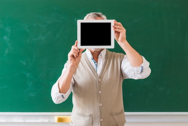 Free photo professor showing blank space on tablet in classroom