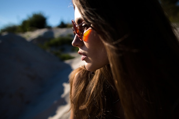 Profile of pretty woman in red sunglasses