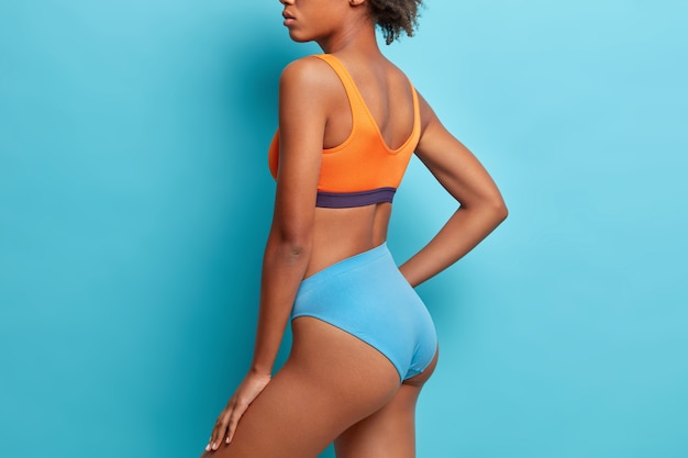 Free photo . profile shot of dark skinned woman has perfect figure buttocks dressed in underwear