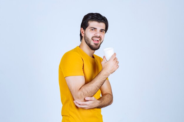 Profile view of a man drinking coffee.