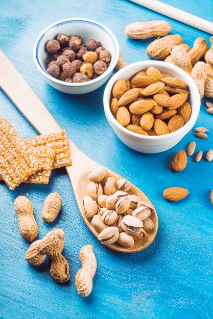 Proteins bar made with dried fruits on blue texture background