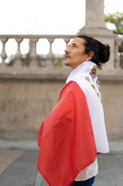 Free Photo proud man wearing mexican flag  side view