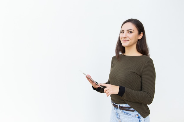 Proud satisfied beautiful woman holding tablet