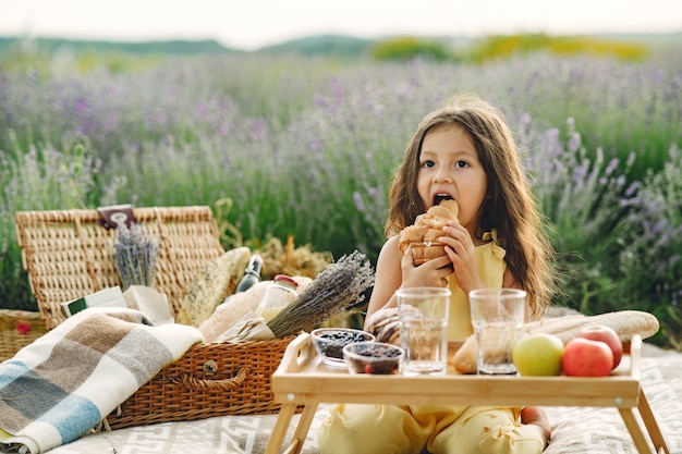 Free Photo provence child relaxing in lavender field. little girl in a picnic.