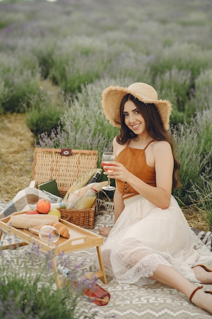 Free photo provence woman relaxing in lavender field. lady in a picnic.