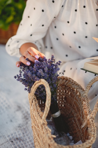 Provence woman relaxing in lavender field. Lady in a white dress.