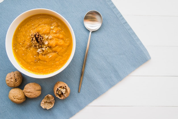 Pumpkin puree in bowl with walnuts