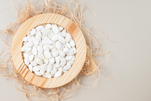 Pumpkin seeds in plates on a concrete.