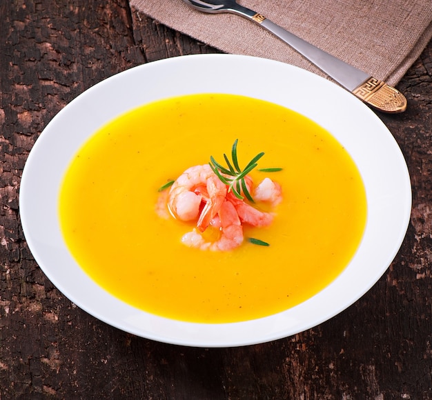 Pumpkin soup with shrimp and rosemary