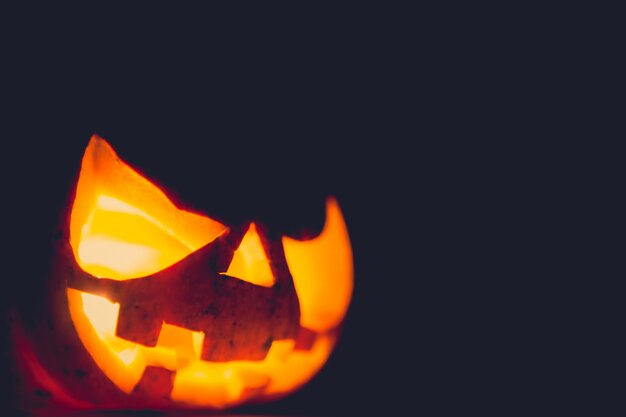 Pumpkin with light inside on a dark background