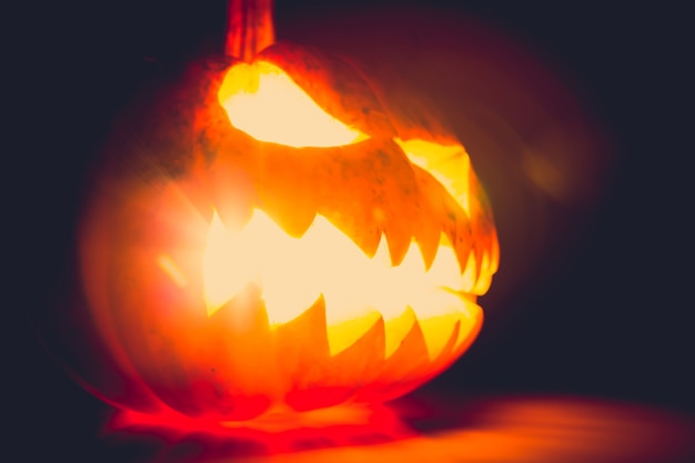 Pumpkin with light inside on a dark background