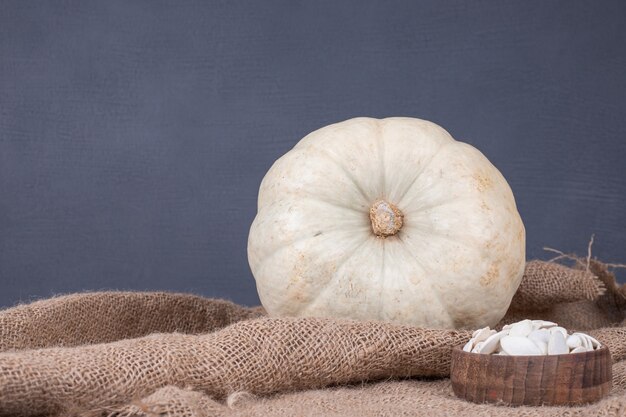 Pumpkin with seeds on burlap.