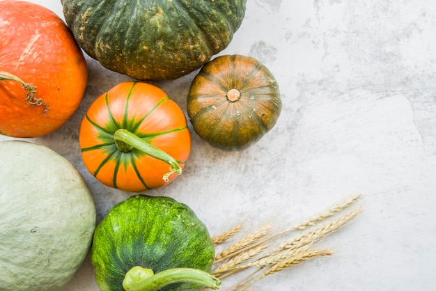 Pumpkins on table with wheat