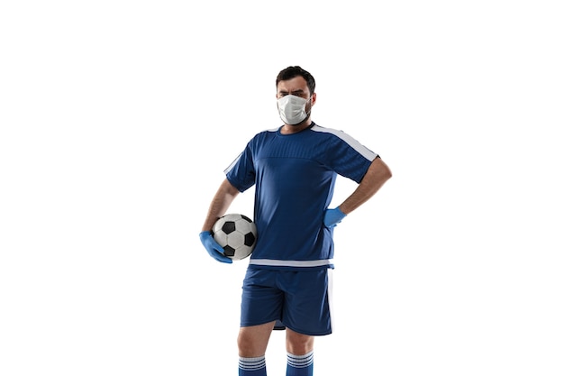 Free photo punching virus. football, soccer player in protective mask and gloves.