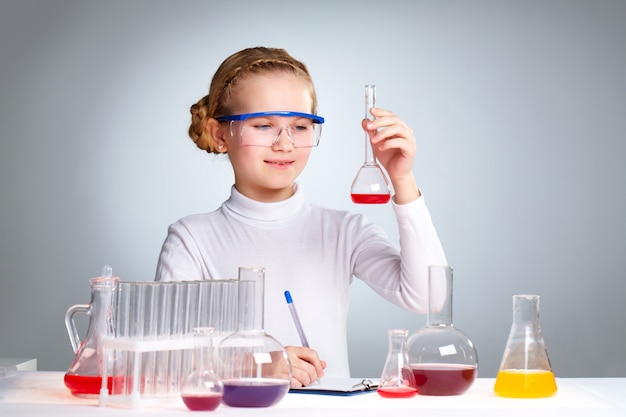 Free photo pupil studying chemistry at school