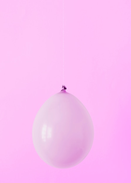 Free Photo purple balloon on pink background