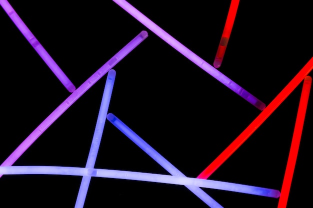 Purple; blue and red neon straws on dark background