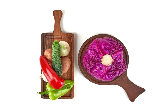 Purple cabbage on a wooden platter with chilies around.