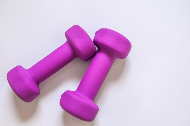 Free Photo purple dumbbells, fitness concept isolated on white background, fitness concept isolated on white background, sport, body building. concept healthy lifestyle, sport and diet. sport equipment. copy space