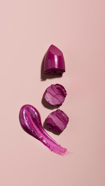 Purple lipstick shade on pink background top view