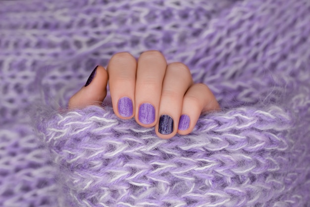 Free Photo purple nail design. manicured female hand on purple background.