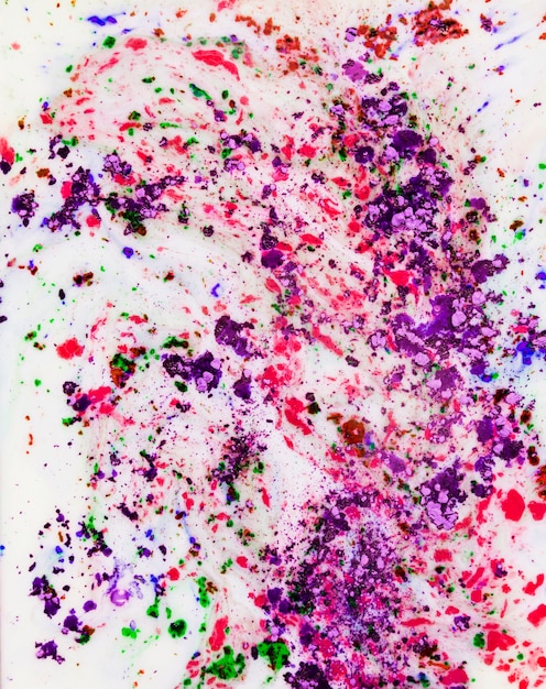 Free photo purple; pink and green holi color powder mixed on white background