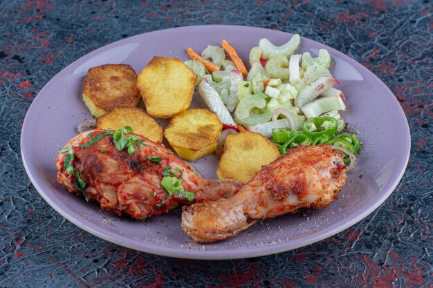 A purple plate of delicious meat with vegetables