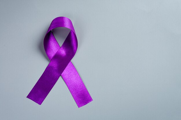 Purple ribbon on the wooden surface.