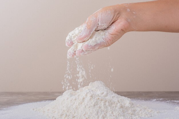 Putting all purpose flour to make dough