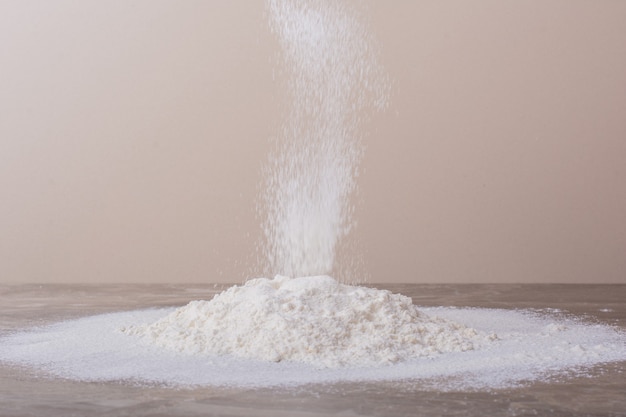 Free photo putting flour on ground for dough making.