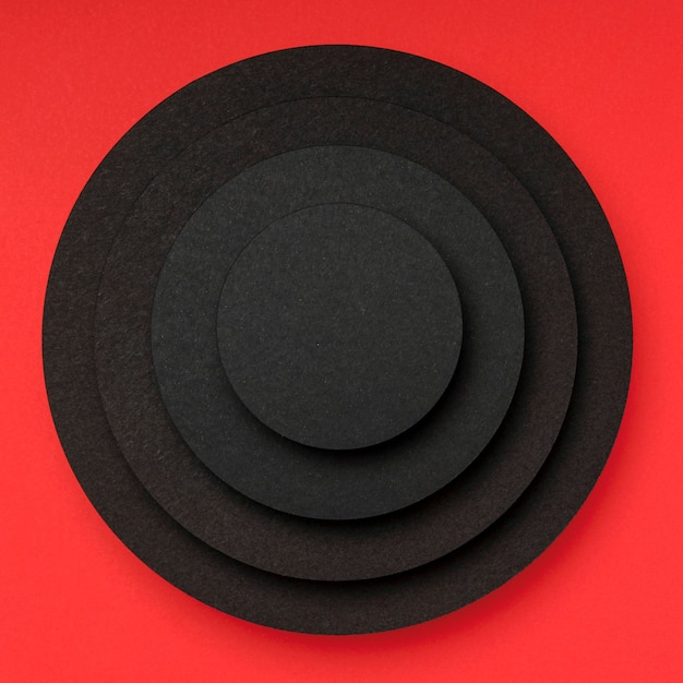 Free Photo pyramid of circular pieces of black paper