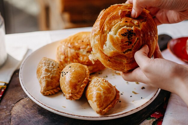 qoghal along with meat filled pastries salted designed yummy inside white plate