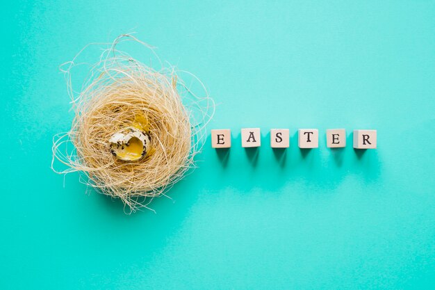 Quail egg in nest and Easter word