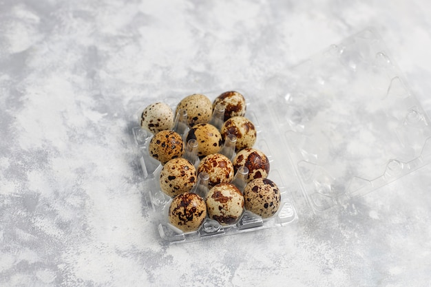 Free Photo quail eggs on a white-grey concrete  